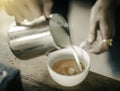 Coffee maker pouring the milk for make latte art Royalty Free Stock Photo