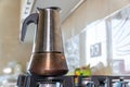 Coffee maker on the stove. Italian espresso coffee maker or Moka pot on the gas stove. Metal coffee maker in a kitchen