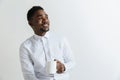 Coffee makes his day. Young handsome African man drinking coffee and looking away