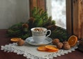 Coffee, marshmallow, walnuts, christmas tree branches near a wooden snowy window. Christmas and New Year card