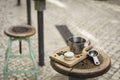 Coffee metal cup and roasted coffee beans with a small cheese cake on vintage and rustic kitchen board in a small restaurant in Royalty Free Stock Photo