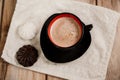 Coffee with milk in a black stylish cup and two marshmallows. Royalty Free Stock Photo