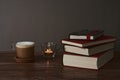 Coffee with milk and books on a brown wooden table.