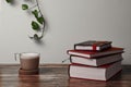 Coffee with milk and books on a brown wooden table.