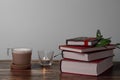 Coffee with milk and books on a brown wooden table.