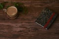 Coffee with milk and books on a brown wooden table.