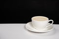 Coffee with milk cream, cappuccino in a white ceramic cup on a black white background, copy the place for the text Royalty Free Stock Photo