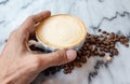 Coffee milk in a cup on marble table. Royalty Free Stock Photo