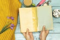 Coffee milk cup and woolen scarf and hands holding old book, felt pen and pocket watch. Royalty Free Stock Photo