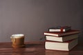 Coffee with milk and books on a brown wooden table.