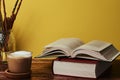 Coffee with milk and books on a brown wooden table. Royalty Free Stock Photo