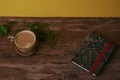 Coffee with milk and books on a brown wooden table.