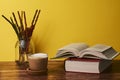 Coffee with milk and books on a brown wooden table. Royalty Free Stock Photo