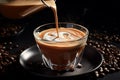 Coffee with Milk Mixture is Poured Into a Small Glass with Black Coffee Beans Background Royalty Free Stock Photo
