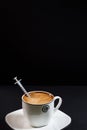 Coffee with milk in a porcelain cup with a syringe inside the cafe Royalty Free Stock Photo
