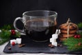 Coffee with milk preparation in glass cup on black background with coffee beans and sugar Royalty Free Stock Photo