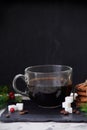 Coffee with milk preparation in glass cup on black background with coffee beans and sugar Royalty Free Stock Photo