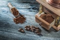 Coffee mill beans on vintage wooden board Royalty Free Stock Photo