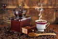 Vintage Coffee Experience: Old Retro Coffee Mill Grinder and Cup of Coffee Royalty Free Stock Photo