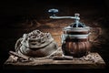 Coffee mill and sack with beans on vintage wood Royalty Free Stock Photo