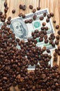 Coffee and money on a wooden table. Earnings on coffee.
