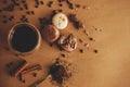 Coffee moody flat lay. Glass cup with fresh coffee and roasted beans,ground coffee on spoon, macarons, chocolate, cinnamon on Royalty Free Stock Photo
