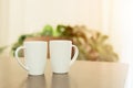 Coffee in the morning, two white tea cup mug placed on wooden table at home Royalty Free Stock Photo