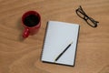 Coffee mug with blank diary, pen and spectacles Royalty Free Stock Photo