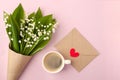 Coffee mug with bouquet of flowers lily of the valley and blank with red heart on pink pastel background, beautiful breakfast Royalty Free Stock Photo