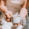 Coffee mug with a bouquet of flowers, spring lilac branches, blooming. Spring mood. Royalty Free Stock Photo