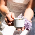 Coffee mug with a bouquet of flowers, spring lilac branches. Spring mood. Wonderful breakfast. Royalty Free Stock Photo