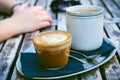 Coffee mug and cake on a wooden vintage table. Hipster concept. Woman drink a coffee. Cups of americano and macchiato. Royalty Free Stock Photo