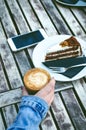 Coffee mug and cake on a wooden vintage table. Hipster concept. Woman drink a coffee. Cups of americano and macchiato. Royalty Free Stock Photo