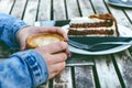 Coffee mug and cake on a wooden vintage table. Hipster concept. Woman drink a coffee. Cups of americano and macchiato. Royalty Free Stock Photo