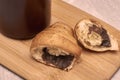 a coffee mug and a croissant broken in half on a cutting board