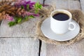 Coffee mug with flowers good morning on white rustic table. Royalty Free Stock Photo