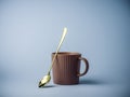 Coffee mug and golden spoon