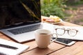 Coffee mug with laptop, glasses and newspaper Business object concept. Royalty Free Stock Photo