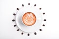 Coffee Mug with Latte Art and coffee beans on white background Royalty Free Stock Photo