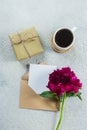 Coffee mug, present box, empty note, card, pink peony flowers. Top view, flat lay style, copy space Royalty Free Stock Photo