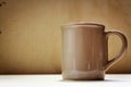 Coffee mug on brown background Royalty Free Stock Photo