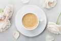 Coffee mug and vintage rose flowers for good morning on gray stone table top view in flat lay style. Beautiful breakfast. Royalty Free Stock Photo