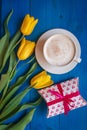 Coffee mug with yellow tulip flowers and gift Royalty Free Stock Photo