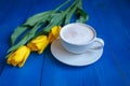 Coffee mug with yellow tulip flowers Royalty Free Stock Photo