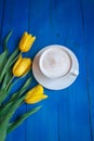 Coffee mug with yellow tulip flowers Royalty Free Stock Photo