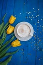 Coffee mug with yellow tulip flowers Royalty Free Stock Photo