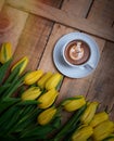 Coffee mug with yellow tulip flowers and notes good morning on blue rustic table from above, breakfast on Mothers or Women day Royalty Free Stock Photo