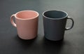 Coffee mugs pink and grey color on black background. Hot beverage cup mockup template