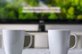 Coffee mugs with a television with a nature documentary and subtitles in background