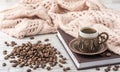 Coffee and notebook with a knitted scarf on a table